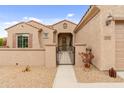 Charming stucco home featuring a gated front porch, tile roof, and desert landscaping at 5649 E Desert Forest Trl, Cave Creek, AZ 85331