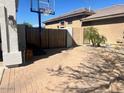 Brick patio with basketball hoop and privacy gate at 6026 E Sonoran Trl, Scottsdale, AZ 85266