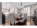 Formal dining room with seating for eight boasts large windows with shutters and decorative chandelier at 6026 E Sonoran Trl, Scottsdale, AZ 85266