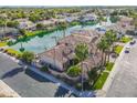 Aerial view of a waterfront house with mature landscaping, tile roof, and a community lake at 633 W Aster Ct, Chandler, AZ 85248