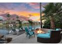 An outdoor fire pit with seating and boat dock on the waterfront creates a relaxing lakeside retreat at 633 W Aster Ct, Chandler, AZ 85248