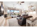 Bright living room with fireplace, waterfront views, and access to the patio at 633 W Aster Ct, Chandler, AZ 85248