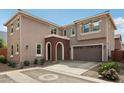 Charming two-story home featuring a brick arched entryway and attached two-car garage at 670 S Beebe St, Gilbert, AZ 85296