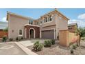 Two-story home with a brick-arched entryway, attached two-car garage and well-maintained landscaping at 670 S Beebe St, Gilbert, AZ 85296
