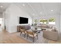 Bright living room with vaulted ceilings, wood floors, a large sofa, and modern furniture at 6701 E San Miguel Ave, Paradise Valley, AZ 85253