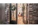 Elegant entryway with wrought iron doors, stone accents, and views of the interior's stylish decor at 7130 E Saddleback St # 58, Mesa, AZ 85207