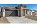 Attractive home with stone accents, a brown garage door, and a convenient concrete driveway at 7718 W Minton St, Laveen, AZ 85339