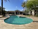 Community pool area featuring crystal clear water, lounge chairs, and covered seating at 8180 E Shea Blvd # 1028, Scottsdale, AZ 85260