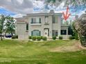 Two-story building featuring green shutters, a manicured lawn, and decorative shrubbery at 8180 E Shea Blvd # 1028, Scottsdale, AZ 85260