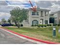 Two-story building featuring green shutters, a manicured lawn, and decorative shrubbery at 8180 E Shea Blvd # 1028, Scottsdale, AZ 85260