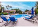 Relaxing community pool featuring lounge chairs and mature shade trees at 10101 N Arabian Trl # 2018, Scottsdale, AZ 85258