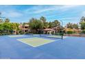 Community tennis courts with mature palm trees and a blue sky at 10101 N Arabian Trl # 2018, Scottsdale, AZ 85258