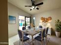 Inviting dining area featuring natural light, stylish furnishings, and access to the backyard at 11022 S Iroquois Dr, Phoenix, AZ 85044