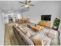Bright living room with open floor plan, wood-look flooring, and modern furnishings at 1211 S Pueblo Ct, Gilbert, AZ 85233