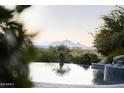 Picturesque mountain views from the edge of an infinity pool, blending nature with luxurious living at 13249 E Summit Dr, Scottsdale, AZ 85259