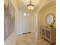 Inviting foyer with tile flooring, stylish decor, and plenty of natural light at 15353 W Cheery Lynn Rd, Goodyear, AZ 85395