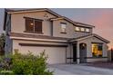 Close-up of a two-story home with neutral colors and dark trim at 1647 W Gold Mine Way, San Tan Valley, AZ 85144