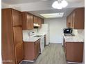 Bright kitchen featuring wood cabinets, modern appliances, and marble-style countertops offering ample counter space at 16602 N 25Th St # 123, Phoenix, AZ 85032