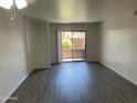 Bright Living room featuring sliding glass door to a balcony with modern flooring and fresh paint at 16602 N 25Th St # 123, Phoenix, AZ 85032