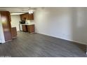 Open living space with hardwood floors flowing into the kitchen, creating a modern and inviting atmosphere at 16602 N 25Th St # 123, Phoenix, AZ 85032