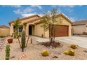 Tan single-story home featuring desert landscaping with cacti and a gravel yard at 18102 E El Viejo Desierto --, Gold Canyon, AZ 85118