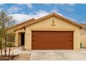 Charming tan single-story home with a brown two-car garage at 18102 E El Viejo Desierto --, Gold Canyon, AZ 85118