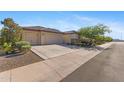 Attractive house featuring a three-car garage and desert-friendly landscaping at 18387 W Mountain Sky Ave, Goodyear, AZ 85338