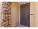Close-up of a secure front door with decorative ironwork and stone accents at 18387 W Mountain Sky Ave, Goodyear, AZ 85338