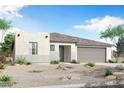 A charming single-story home featuring a neutral color palette, low-maintenance landscaping, and an attached garage at 18522 W Mohave St, Goodyear, AZ 85338