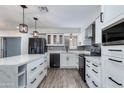 Modern kitchen with white cabinets, quartz countertops, and stainless steel appliances at 2501 E Campbell Ave, Phoenix, AZ 85016