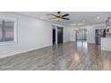 Bright, open-concept living room with sleek floors, modern lighting, and sliding barn door at 2501 E Campbell Ave, Phoenix, AZ 85016