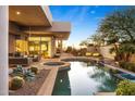 Inviting backyard with a private pool, spa, covered patio, desert landscaping, and scenic views at 28754 N 107Th St, Scottsdale, AZ 85262