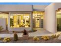 Contemporary home featuring desert landscaping, a modern entrance with oversized windows, and unique architecture at 28754 N 107Th St, Scottsdale, AZ 85262