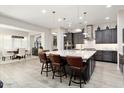 Open-concept kitchen with granite island, stainless steel appliances, and adjacent dining area at 29344 N 132Nd Ln, Peoria, AZ 85383