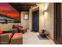Cozy covered patio with comfortable chairs and a decorative iron gate, perfect for relaxing at 29344 N 132Nd Ln, Peoria, AZ 85383
