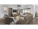 Bright living room featuring modern furnishings, a ceiling fan, and sliding glass doors to the patio at 2962 E Birdsong Ave, San Tan Valley, AZ 85143