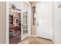 Inviting entryway featuring a decorative tile floor, white front door and study access with glass doors at 3613 W Plymouth Dr, Anthem, AZ 85086
