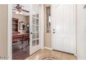 Welcoming foyer with tiled flooring and clear views into a study area through French doors at 3613 W Plymouth Dr, Anthem, AZ 85086