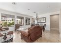 Bright living area with modern tile floors, elegant lighting, and views of the outdoor living space at 3613 W Plymouth Dr, Anthem, AZ 85086