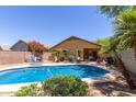 Backyard pool with patio furniture, desert landscaping, and a covered patio is ready for outdoor enjoyment at 4043 S Shady Ct, Gilbert, AZ 85297