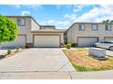 Inviting townhome with a two-car garage, landscaped front yard, and paved driveway at 4301 N 21St St # 3, Phoenix, AZ 85016