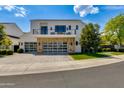 Stunning two-story home with a stone accent, glass garage doors, balcony, and well-maintained landscaping at 4416 N 37Th Way, Phoenix, AZ 85018