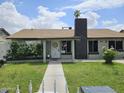 Charming single-story home featuring a well-maintained front yard with mature bushes and a welcoming entrance at 4507 E Saint Catherine Ave, Phoenix, AZ 85042