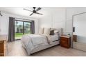 Serene primary bedroom with modern accents, a ceiling fan, and direct access to the backyard at 5238 E Beck Ln, Scottsdale, AZ 85254