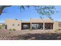 This modern home boasts expansive sliding glass doors that seamlessly connect indoor and outdoor living spaces at 532 E Paint Your Wagon Trl, Phoenix, AZ 85085