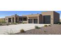 This luxury home features a spacious concrete driveway and a convenient two-car garage, complemented by desert landscaping at 532 E Paint Your Wagon Trl, Phoenix, AZ 85085