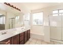 Bright bathroom with tub, shower and large vanity with white countertops at 5329 E Harmony Ave, Mesa, AZ 85206