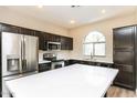Modern kitchen with stainless steel appliances and a white quartz island at 5329 E Harmony Ave, Mesa, AZ 85206