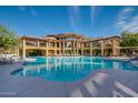 Large community swimming pool with seating and lush landscaping at the Torrana condo complex at 5450 E Deer Valley Dr # 4199, Phoenix, AZ 85054