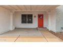Inviting front porch with a red door and white pillars, complemented by a decorative window at 6038 W Gelding Dr, Glendale, AZ 85306
